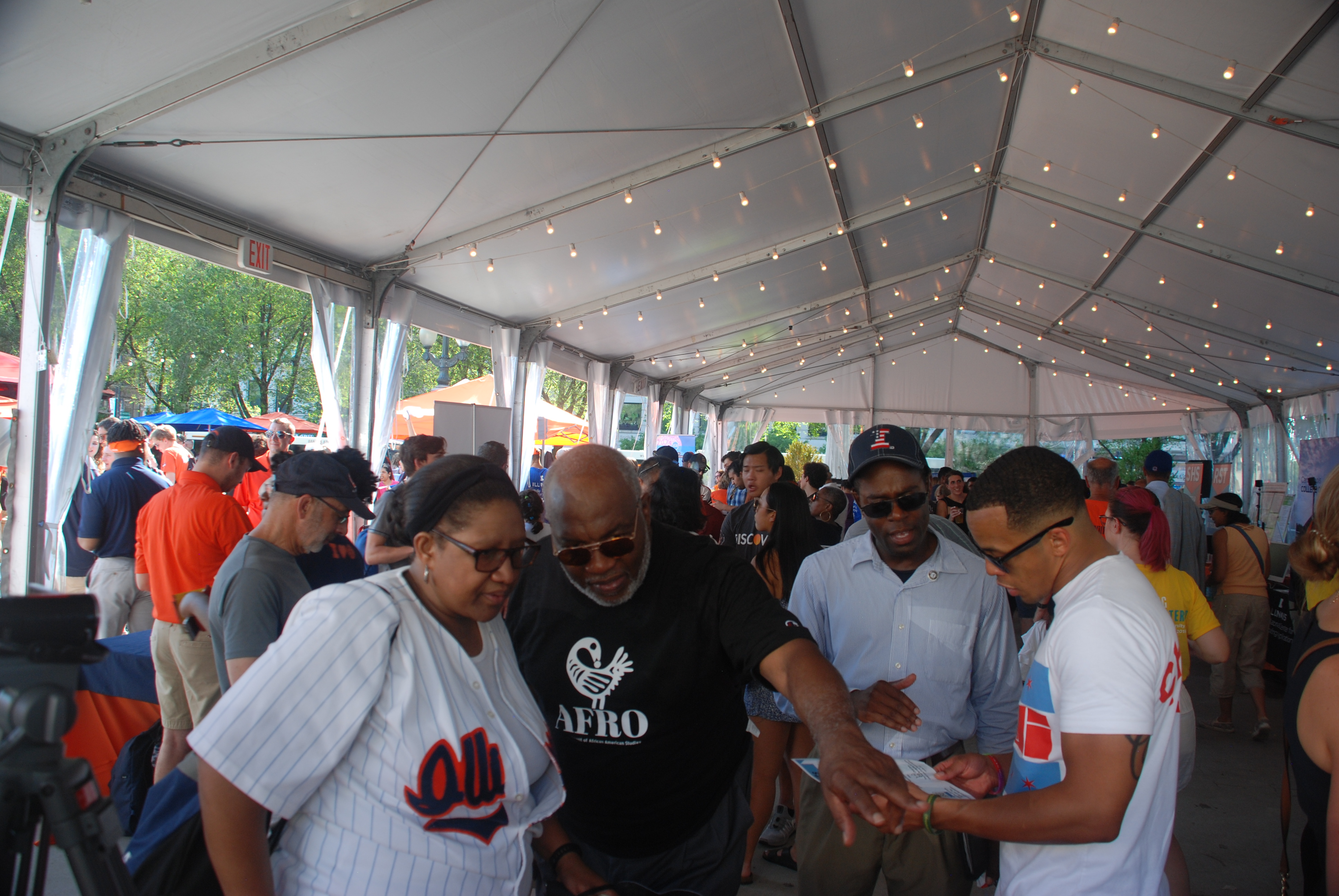 A group at the AFRO table speaking with Dr. Bailey